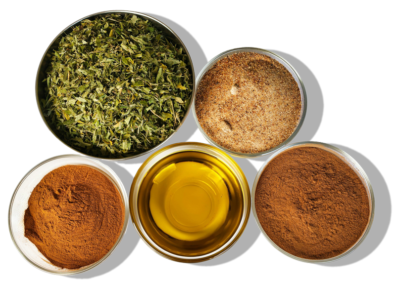 Top view of various spices and dried herbs in small bowls, including ground cinnamon, ground paprika, ground chili powder, dried herbs, and oil, against a black background.