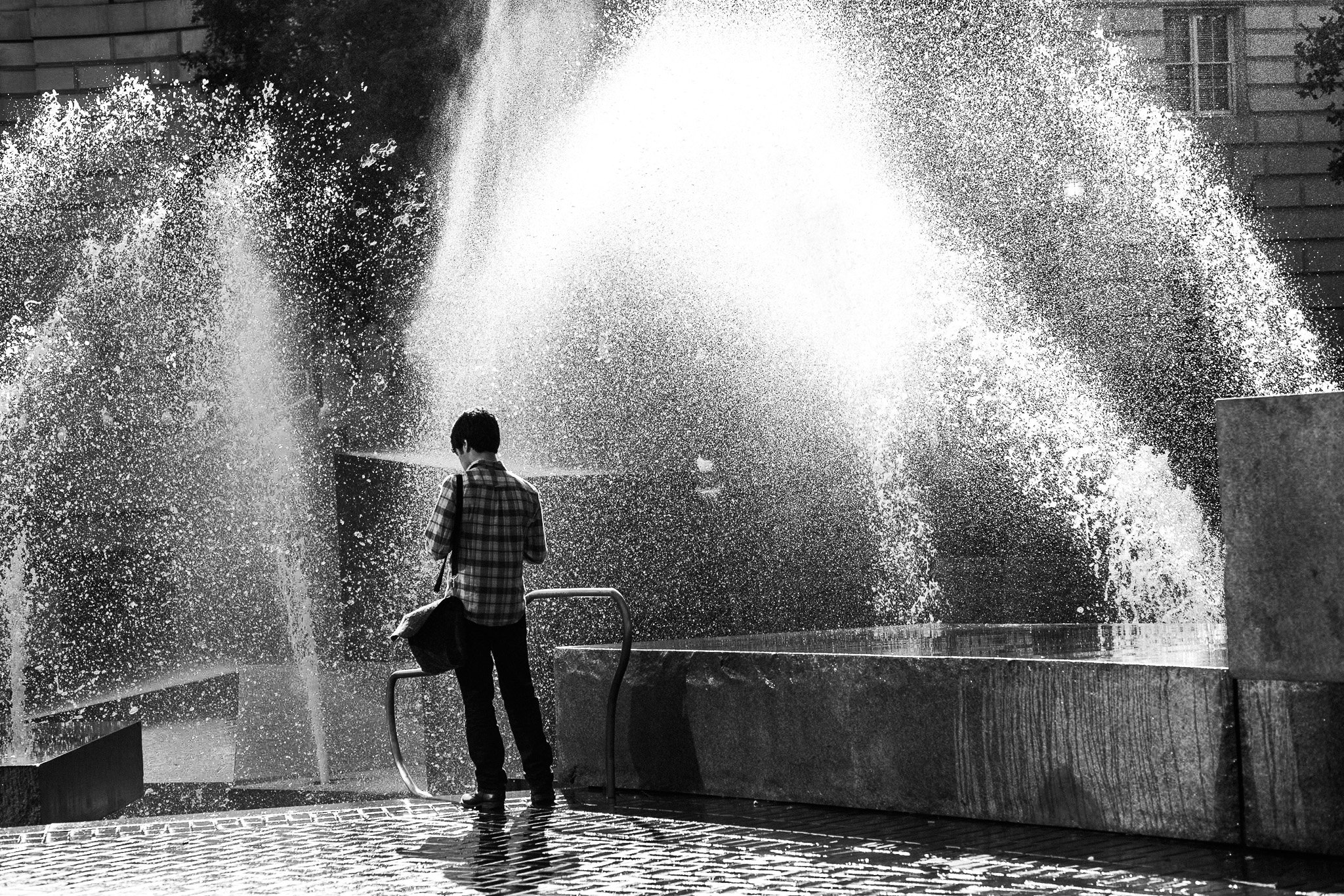 "Mist & Message" Amid the roar of a downtown fountain, a lone figure pauses, absorbed in their phone as water rains around them. The spray blurs the noise of the city, holding a moment of stillness in motion. In San Francisco, even in the chaos, ther