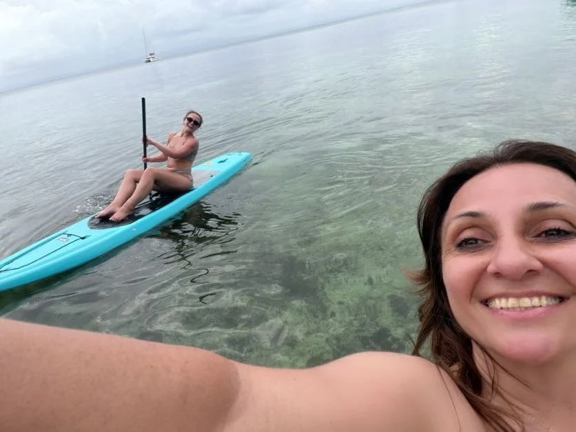 Woman in paddleboard with Dani in corner of the image 