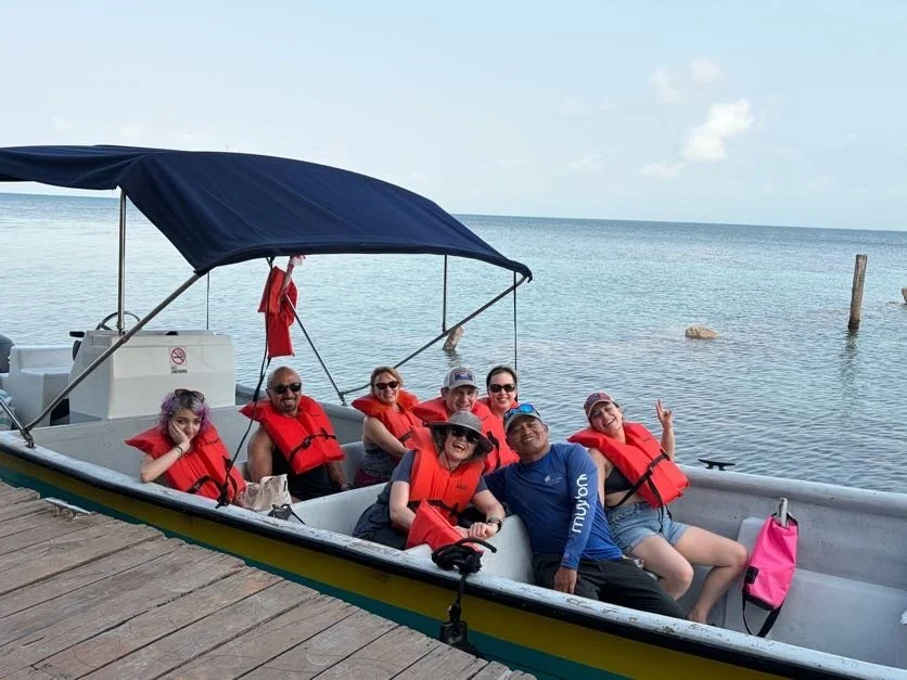 The Prema Vanda Group in a boat with life jackets