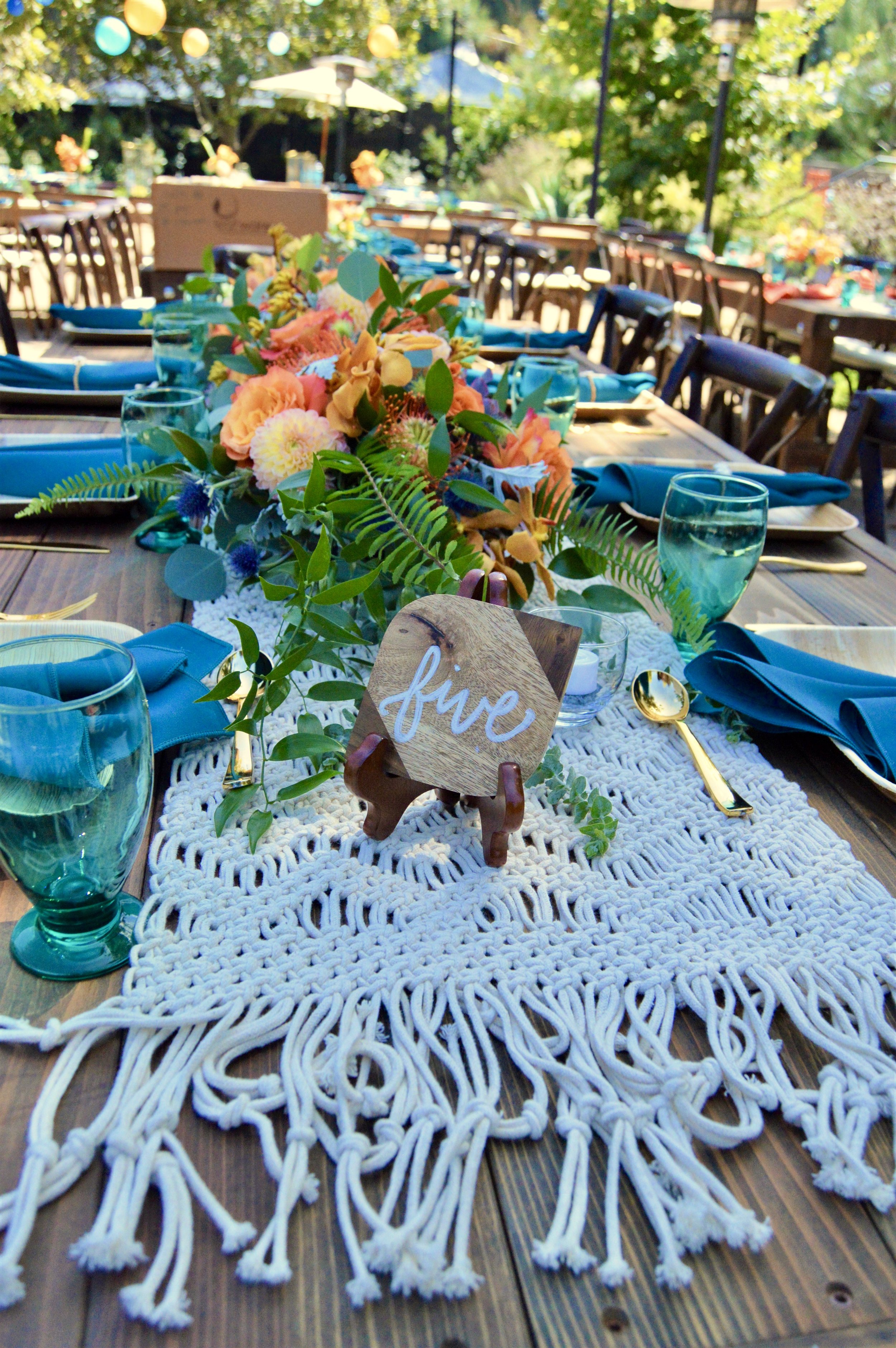 Table setting with floral centerpiece and sign.jpg