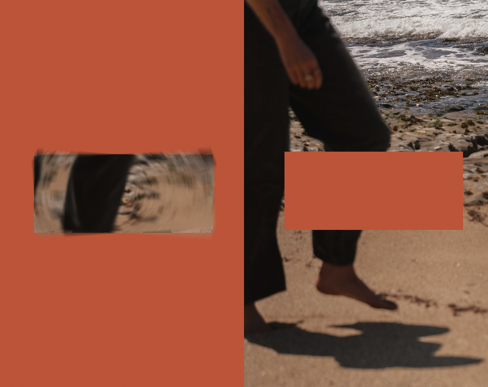 A person standing barefoot on a sandy beach near the water, with visible waves and rocks. The person's shadow is cast onto the sand, and they are wearing dark clothing. The person's face is not visible, but their arm and hand are partially shown.