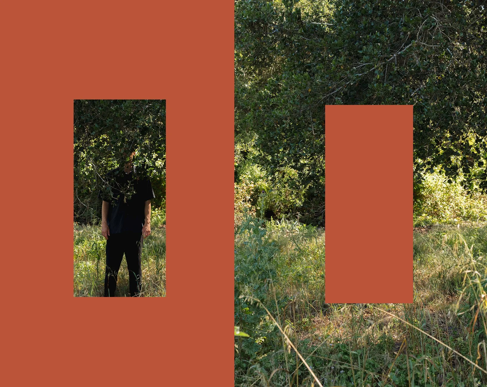A person dressed in black standing outdoors in front of dense greenery, with a background of trees and bushes.
