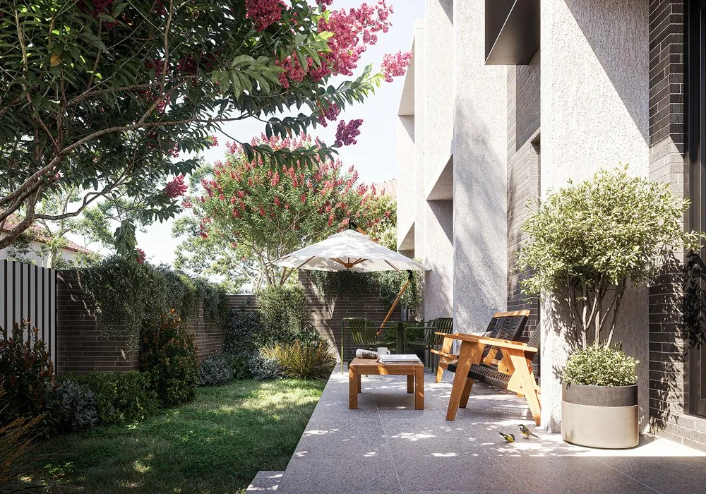 Outdoor patio with wooden bench, black chairs, a white umbrella, potted trees, and flowering plants, adjacent to a modern building with textured walls.