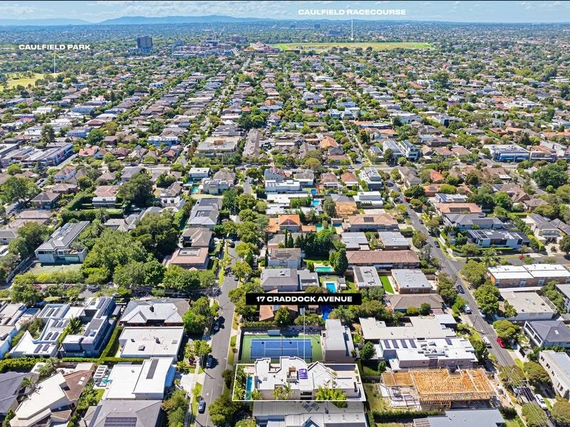 Aerial view of a suburban neighborhood with houses, trees, and streets, showing 17 Craddock Avenue and Caulfield Park and Caulfield Racecourse in the background.