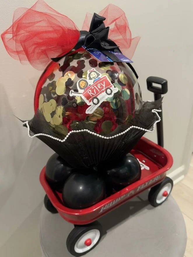 Custom Riley Hospital Themed Piece - Stuffed Bubble Balloon with a small red wagon inside with black and red balloons and confetti. Placed in a themed Red Wagon. 