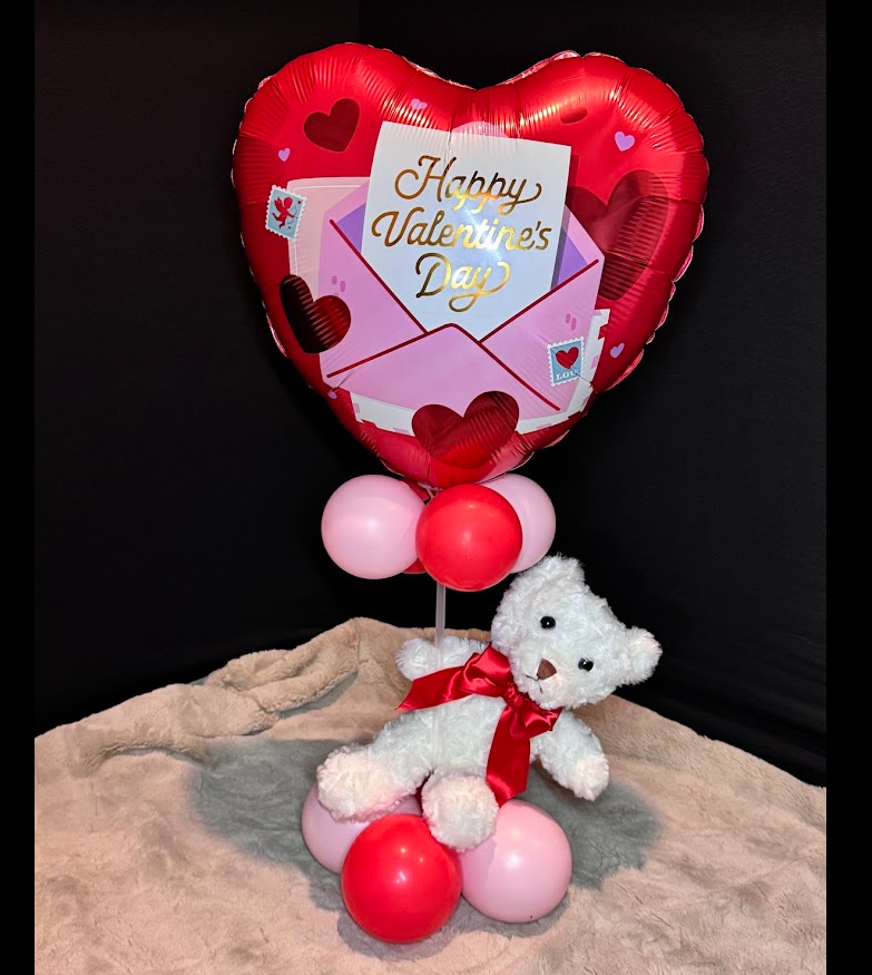 Valentine's Day foil heart balloon tower with red and pink balloons and white teddy bear. 
