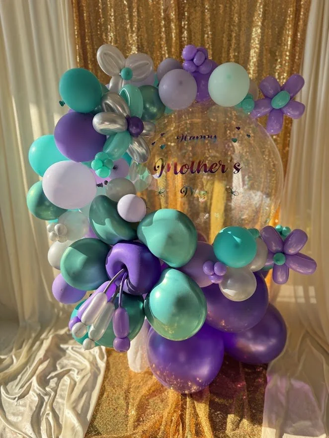 Wrapped Bubble Balloon with teal, purple and silver balloons. Vinyl Happy Mother's Day wording. 3D flower in matching colors. 