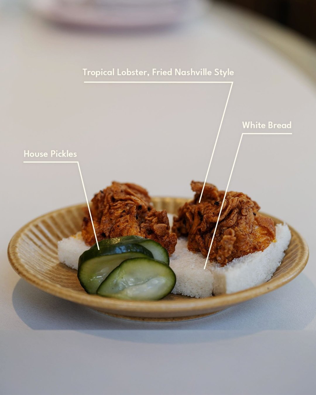 This starter is not here to play: Tropical Rock Lobster Nashville Style with pickles and white bread. It's punchy, crispy, and the kind of plate that makes the table go quiet for a second. If you're planning a proper night out in Fish Lane, book Clar