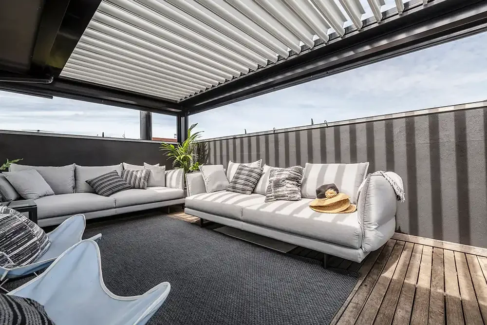 Indoor-outdoor rooftop terrace with stylish lounges, professionally photographed for a high-performing Melbourne Airbnb listing.