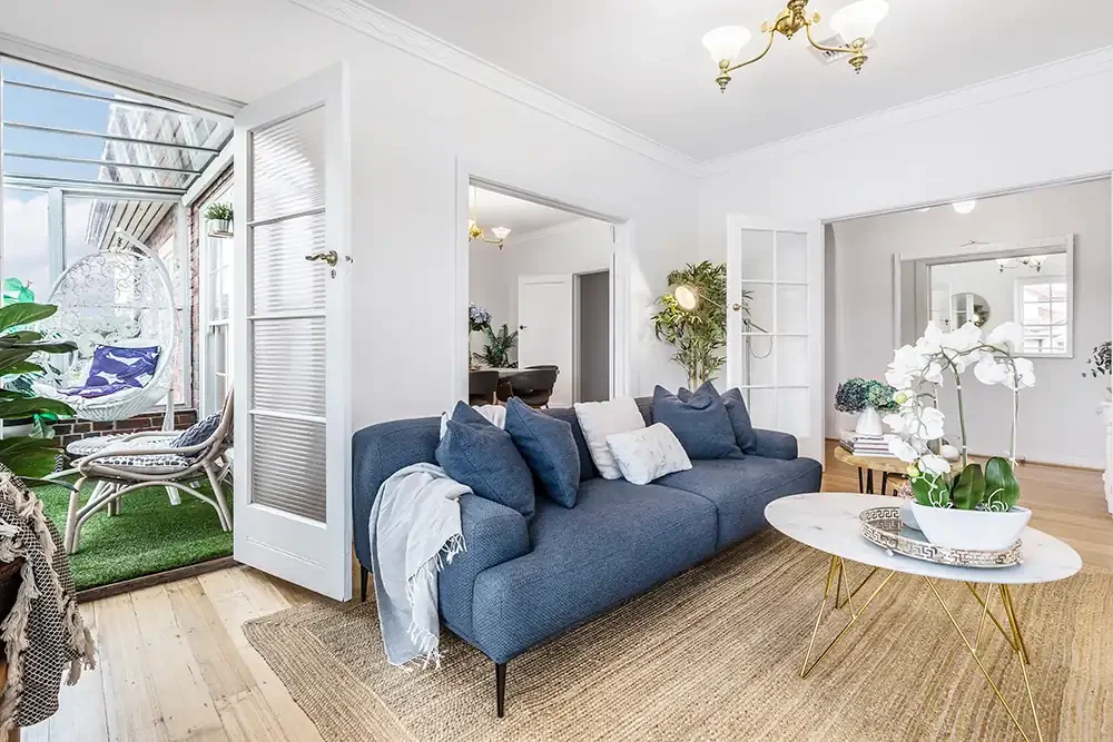 Sun-drenched Williamstown lounge room with natural light, professionally photographed for a premium Airbnb listing.