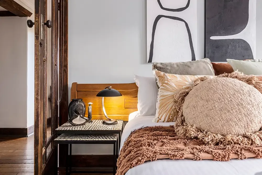 Ornate bedroom furnishings in South Yarra, highlighting detail-driven photography for luxury short-term rentals.