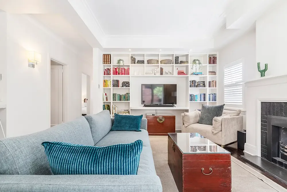 Modern Prahran lounge room featuring a large white bookshelf, captured by professional Airbnb photographer in Melbourne.