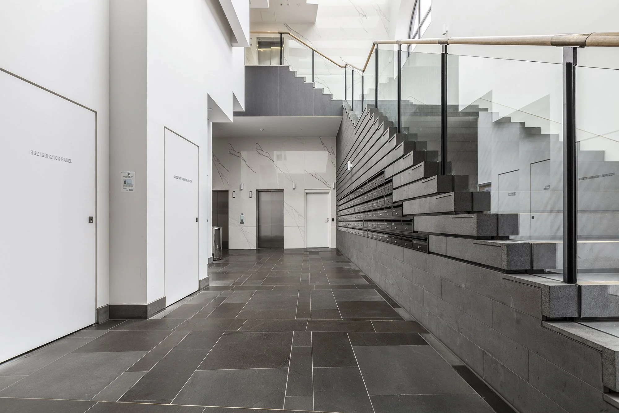 Modern building lobby and staircase at a Richmond Airbnb apartment complex