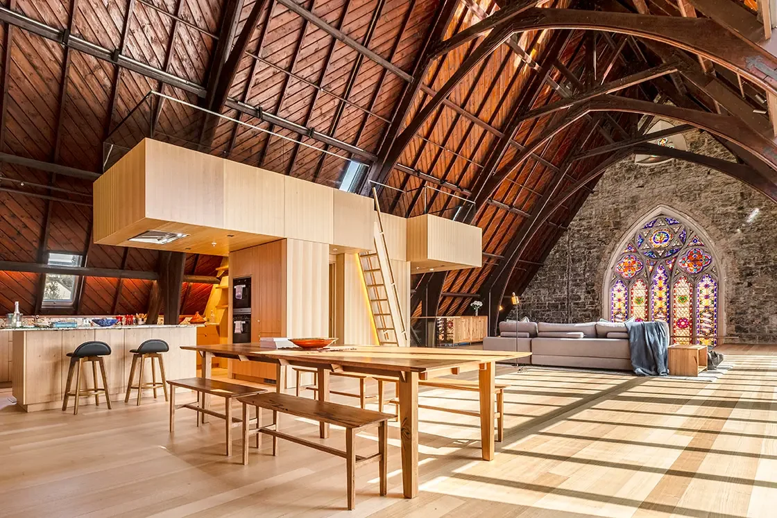 Interior of a converted bluestone church with open plan kitchen and living spaces. Professionally photographed Airbnb listing by Andrew Para