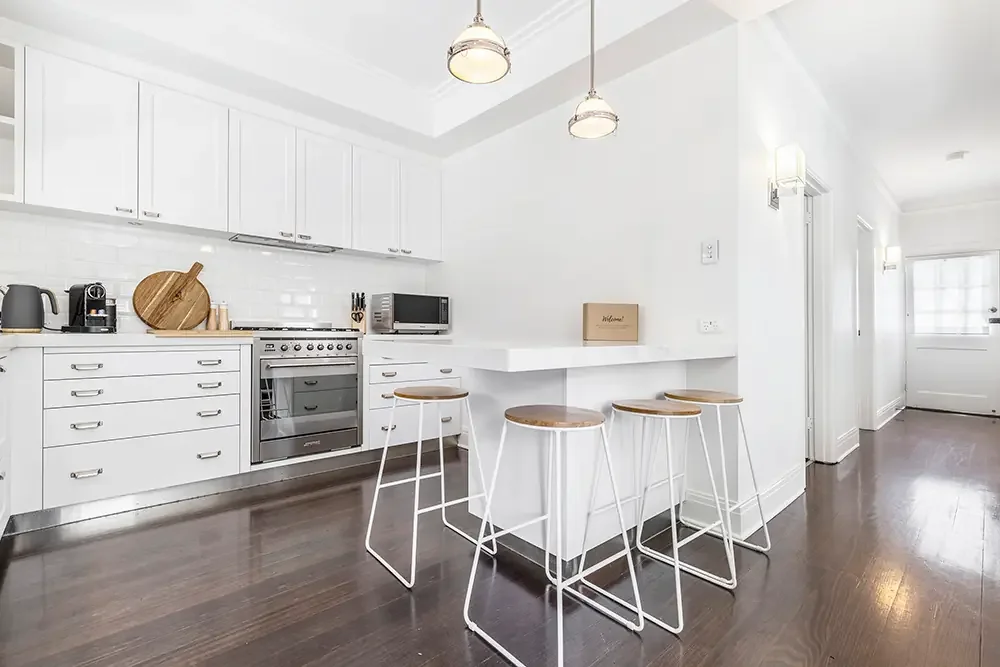 Open-plan kitchen and breakfast bar in Prahran, showcasing professional property photography for short-term rentals.
