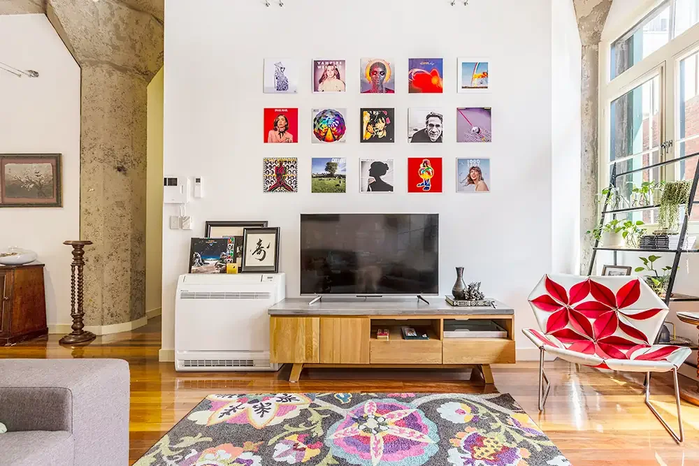 Drewery Lane lounge room featuring wall decor and TV area, captured to showcase urban Melbourne living.