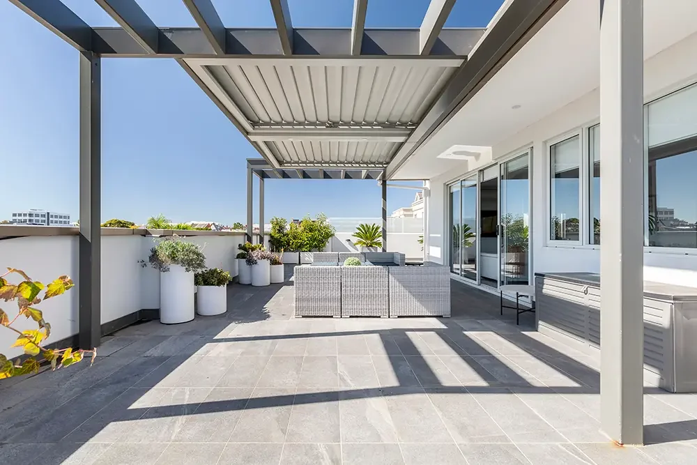 Undercover outdoor terrace in Malvern with grey tiles, showcasing professional real estate photography in Melbourne.