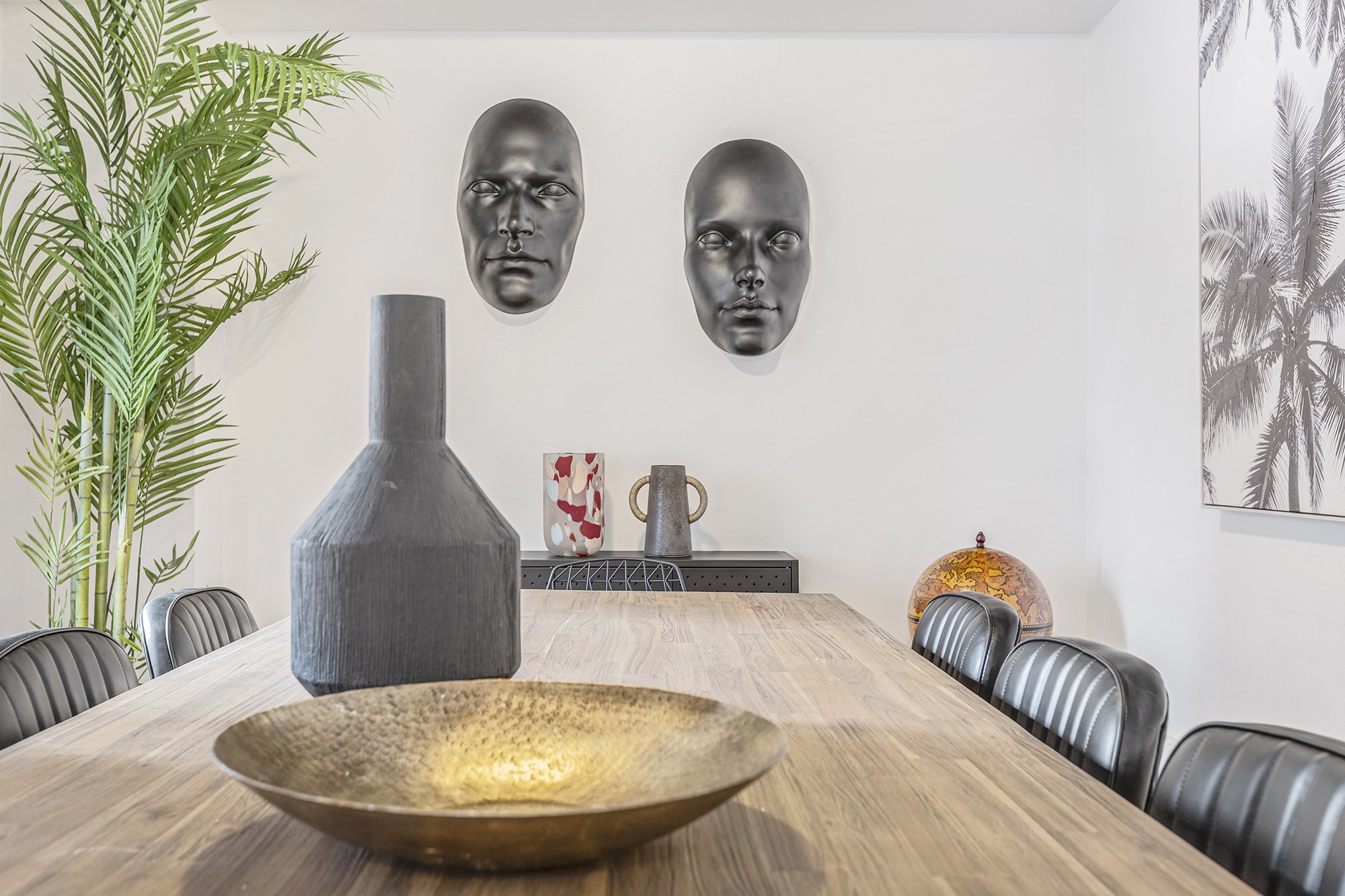 Dining table styling detail in a Melbourne CBD Airbnb, featuring sculptural decor and greenery