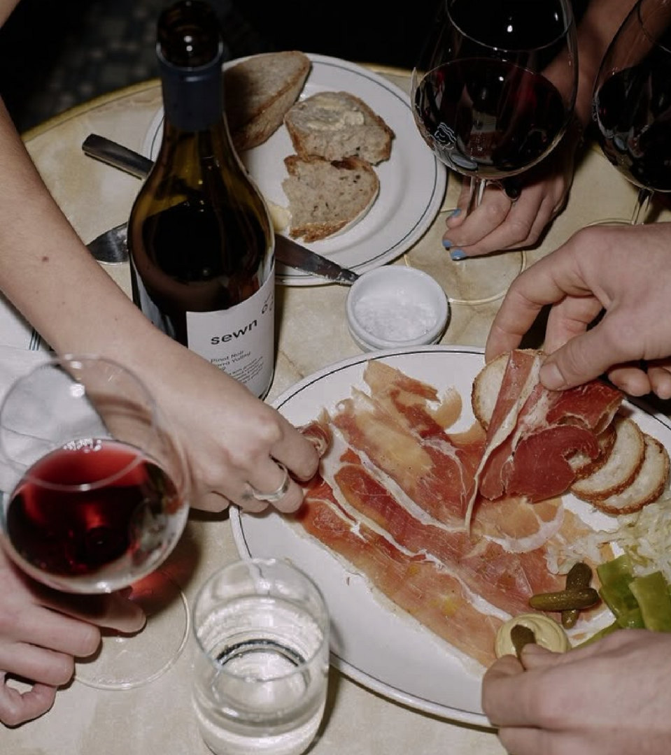 A table with shared bottle of wine and some nibbles at Annabel's Wine Bar