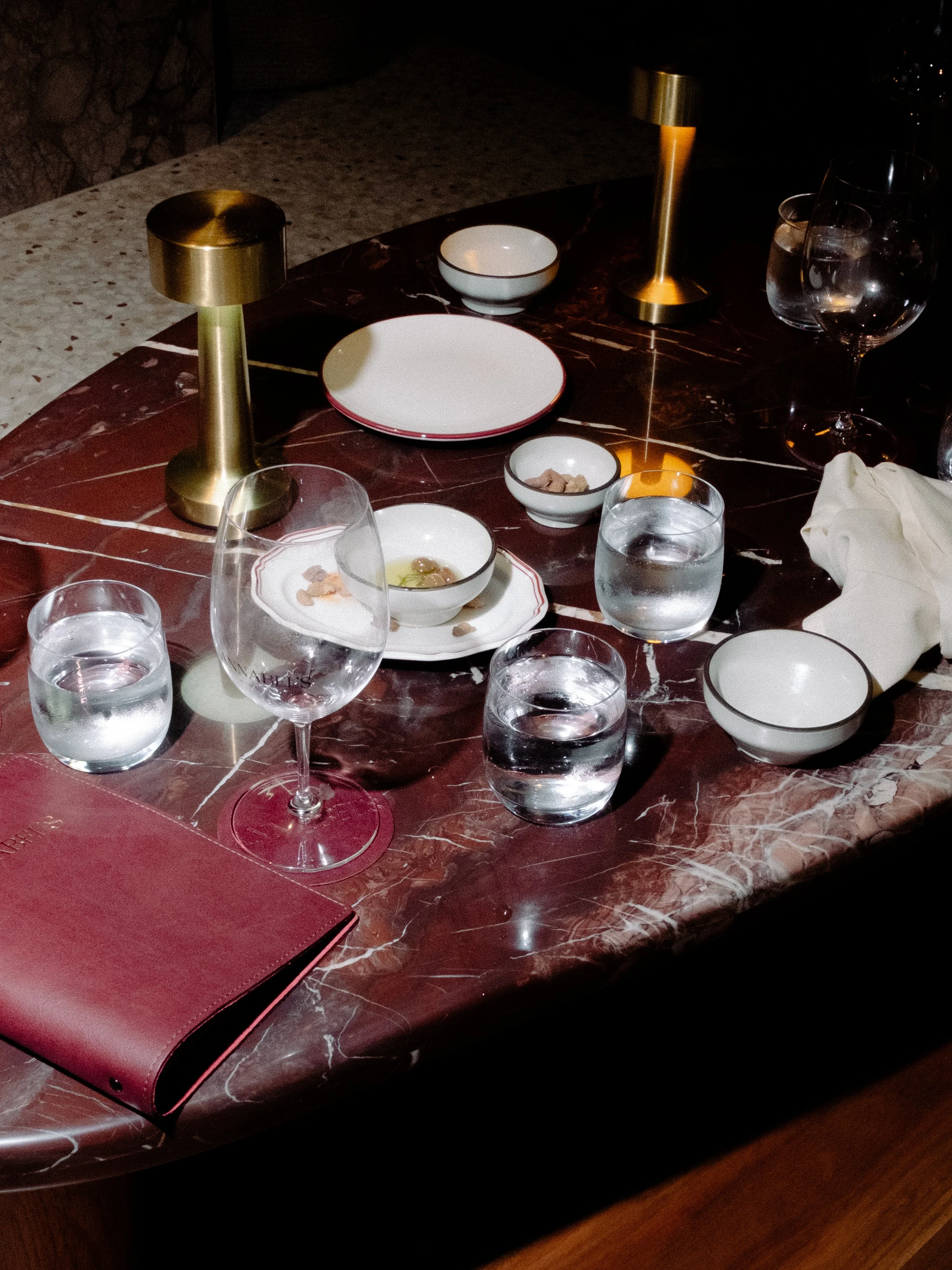 Annabel's Wine Bar red marble table with food and drinks
