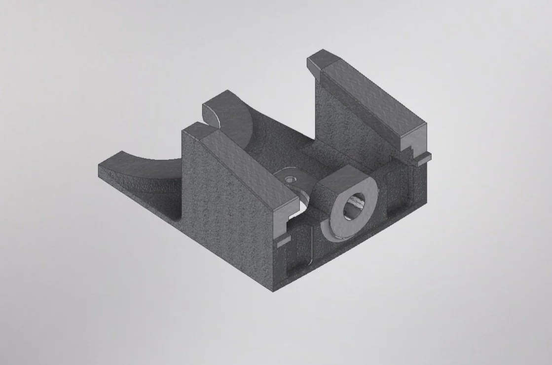 A 3D digital rendering of a black mechanical part with various cutouts and features, resembling a mounting bracket or clamp.