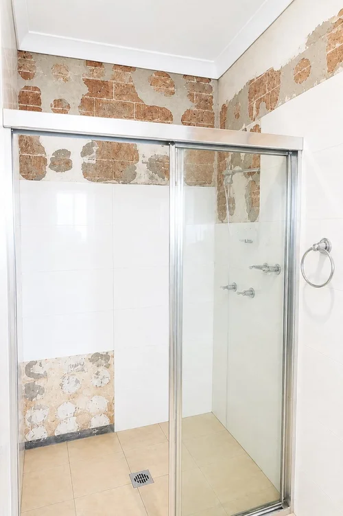 Damaged bathroom tiles before repair