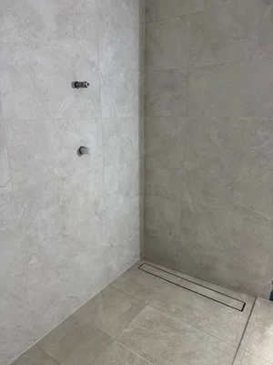 Large format stone look shower project by Paiva Tiling Co