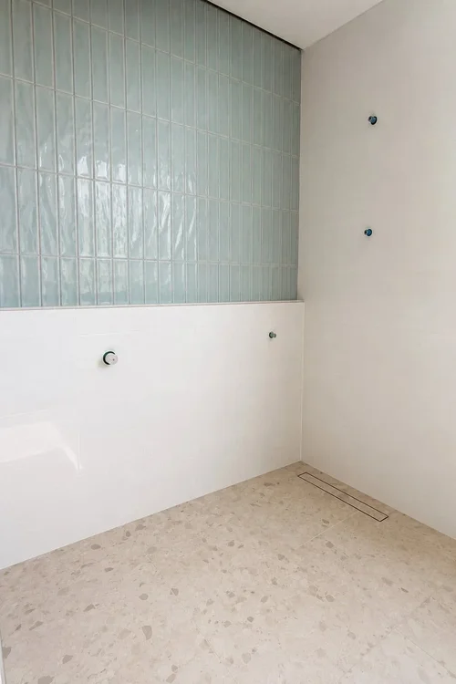 Soft green vertical subway tile feature wall