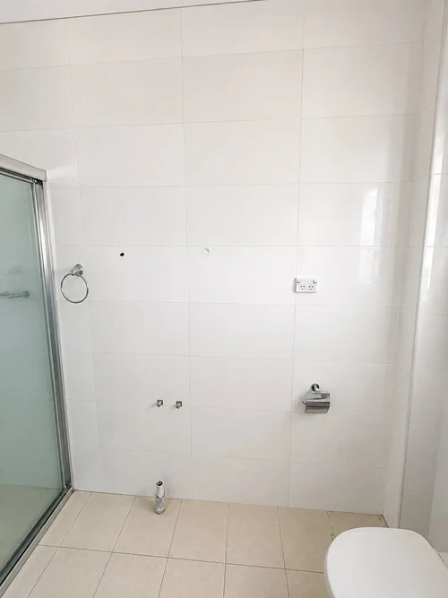 Bathroom wall tile repair completed