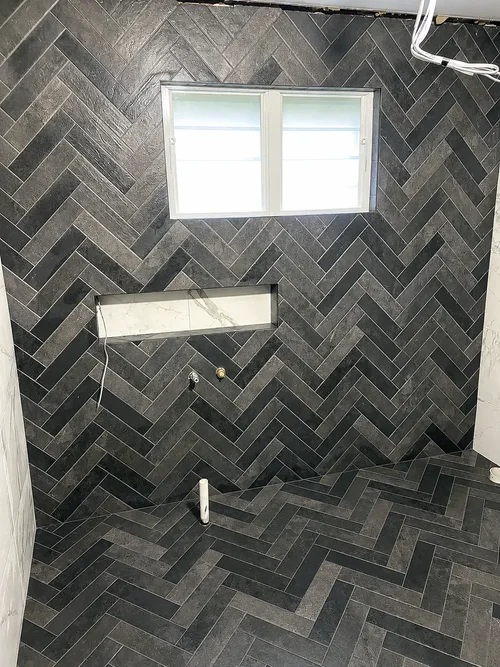Dark Herringbone bathroom wall and floor tiling