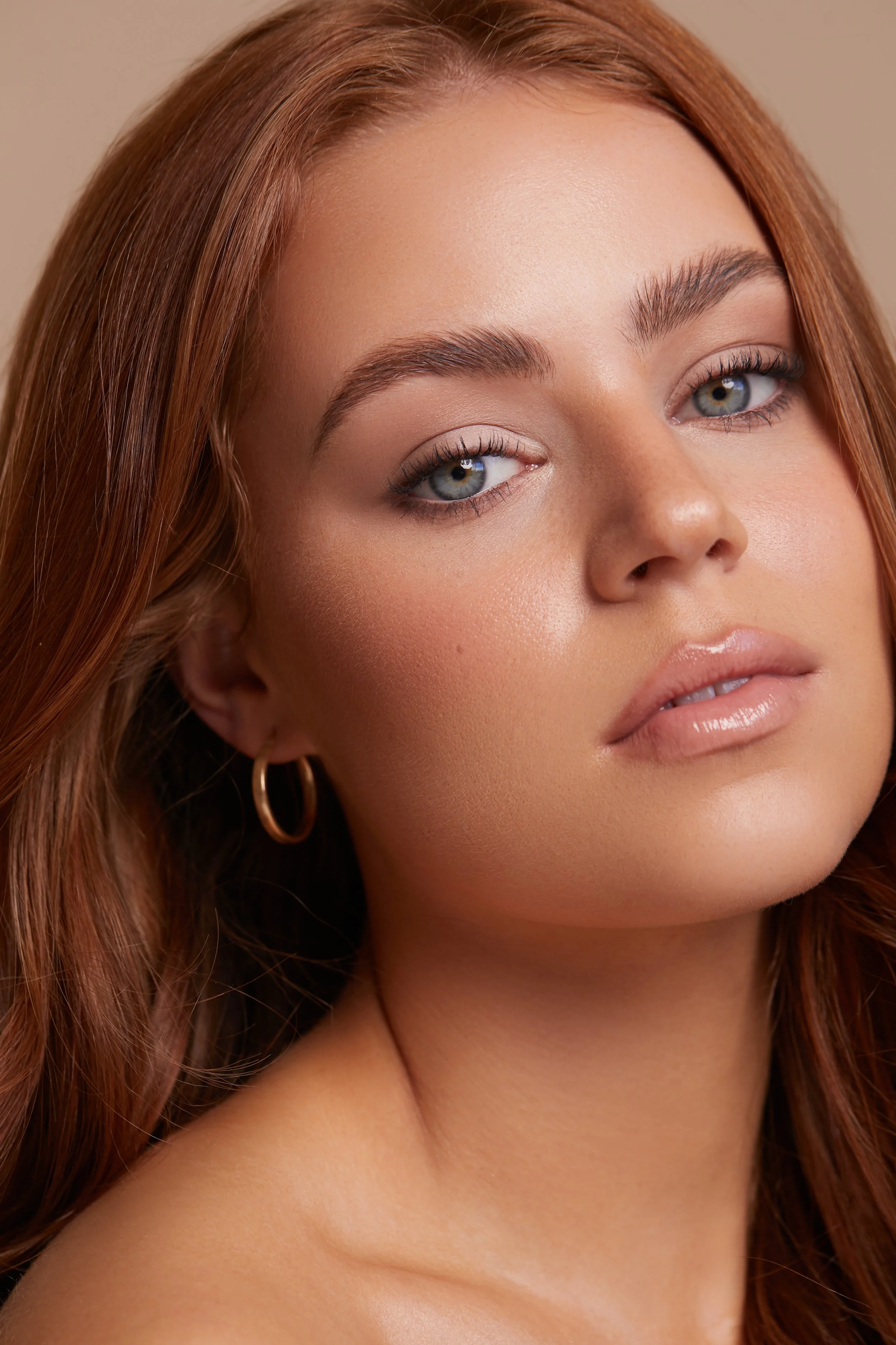 Editorial makeup by a Sydney commercial makeup artist, featuring softly defined eyes, glowing skin and peach nude lips.