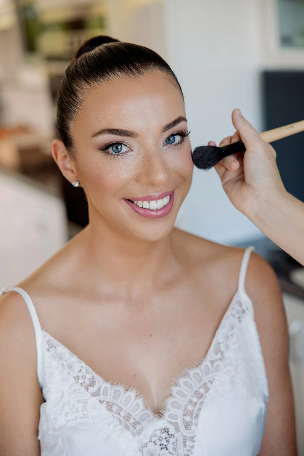 Glowing bride having soft glam makeup applied, with glowing skin and an elegant updo, by a Sydney bridal hair and makeup artist.