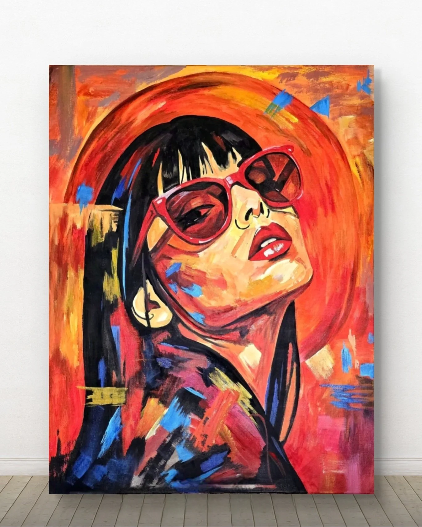 Abstract portrait of a woman wearing large red sunglasses, with black hair, set against a vibrant orange and red background with blue accents.