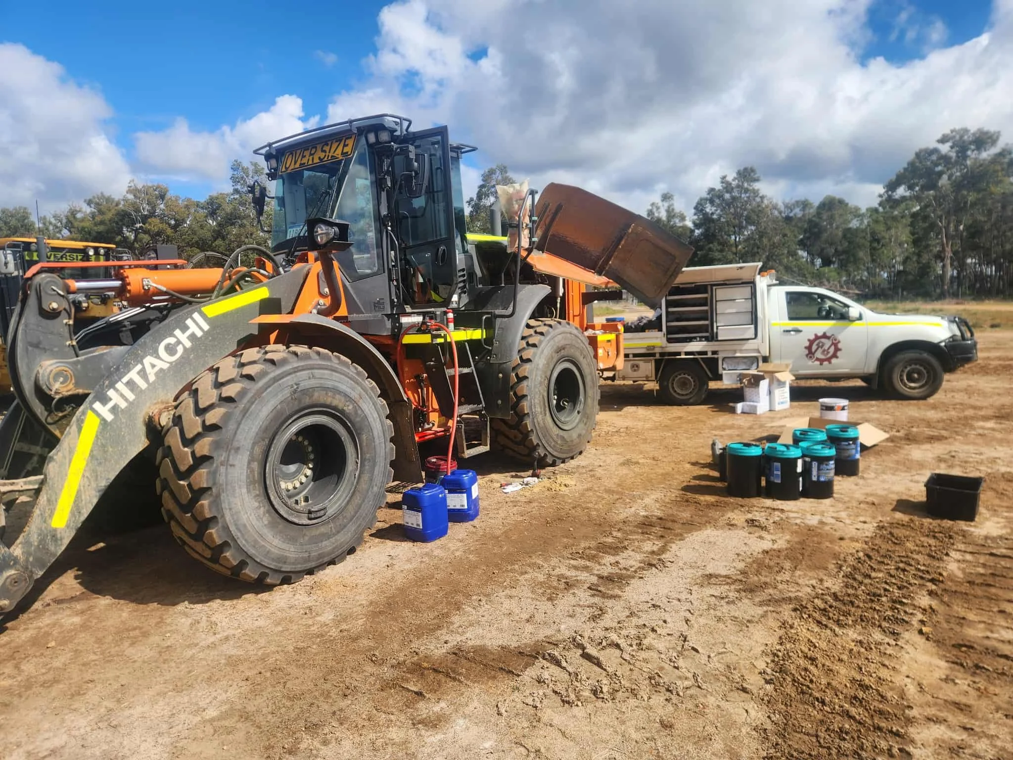 Loader being serviced onsite with a Balamara ute in background