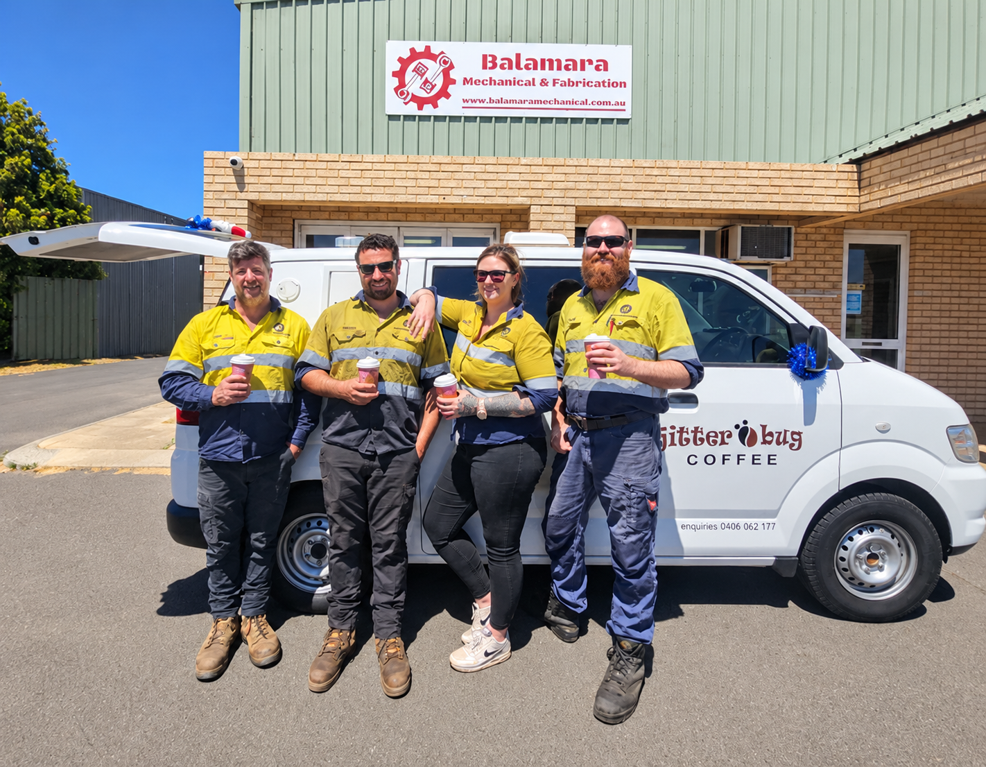 Four Balamara Mechanical team members outside the workshop beside a mobile coffee van