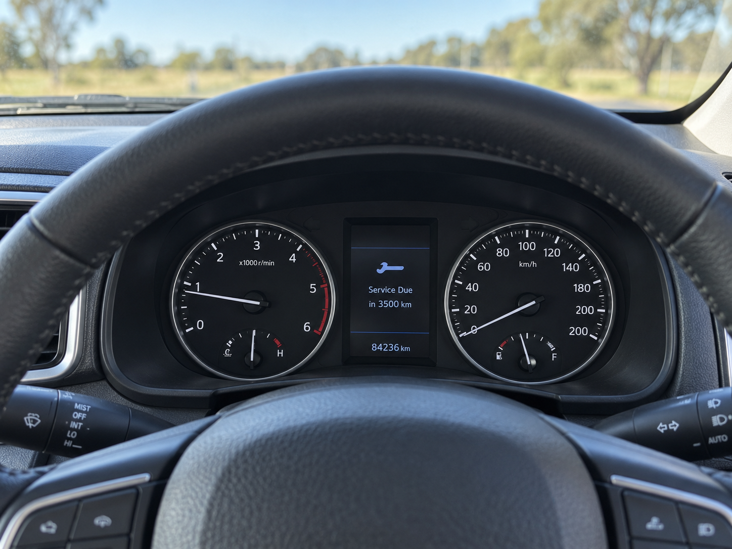 Vehicle dashboard showing an upcoming service reminder