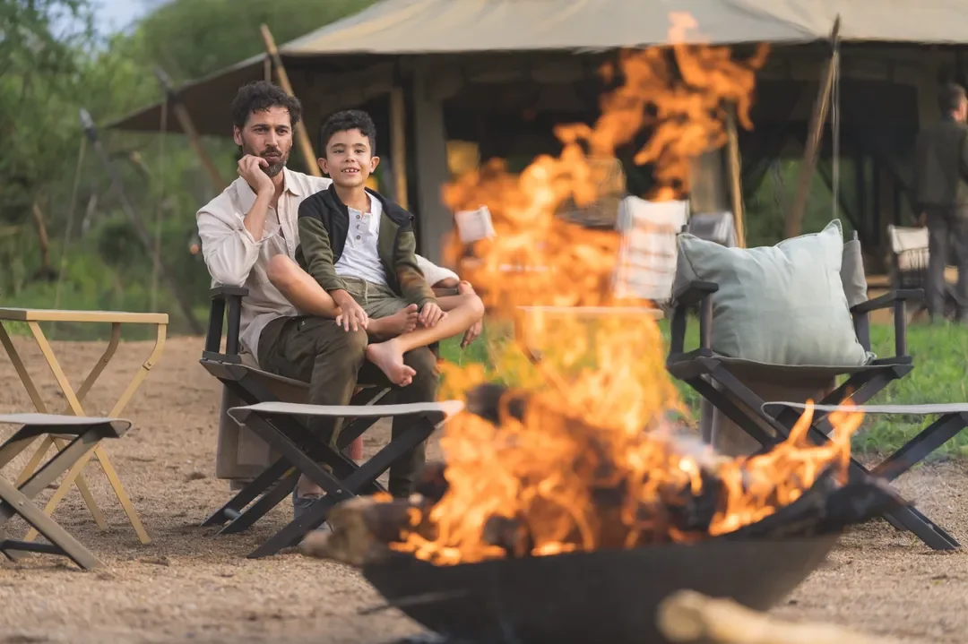 Evening campfire at Mila Tented Camp with Serengeti views