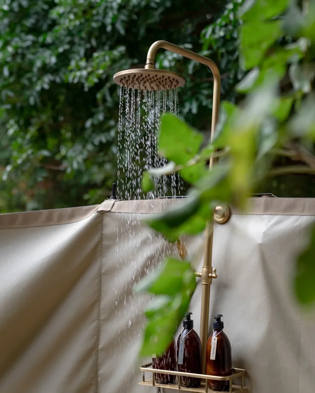 Open air brass shower at Time + Tide Luwi bush bathroom, South Luangwa