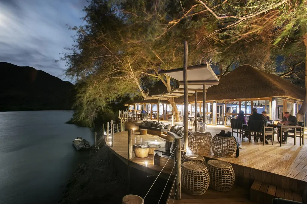 Serra Cafema deck at night with riverside dining on the Kunene River, Kunene Namibia
