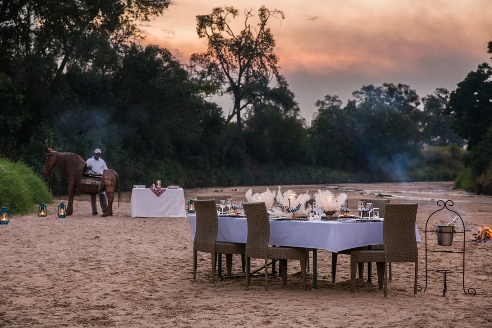 Private al‑fresco dining setup with wide savannah views — Sala’s Camp, Maasai Mara