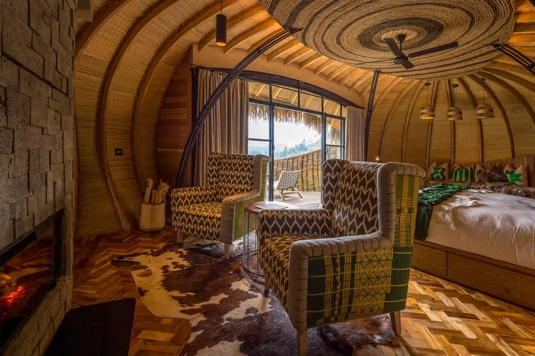 Bisate Lodge suite lounge with fireplace and private deck Rwanda