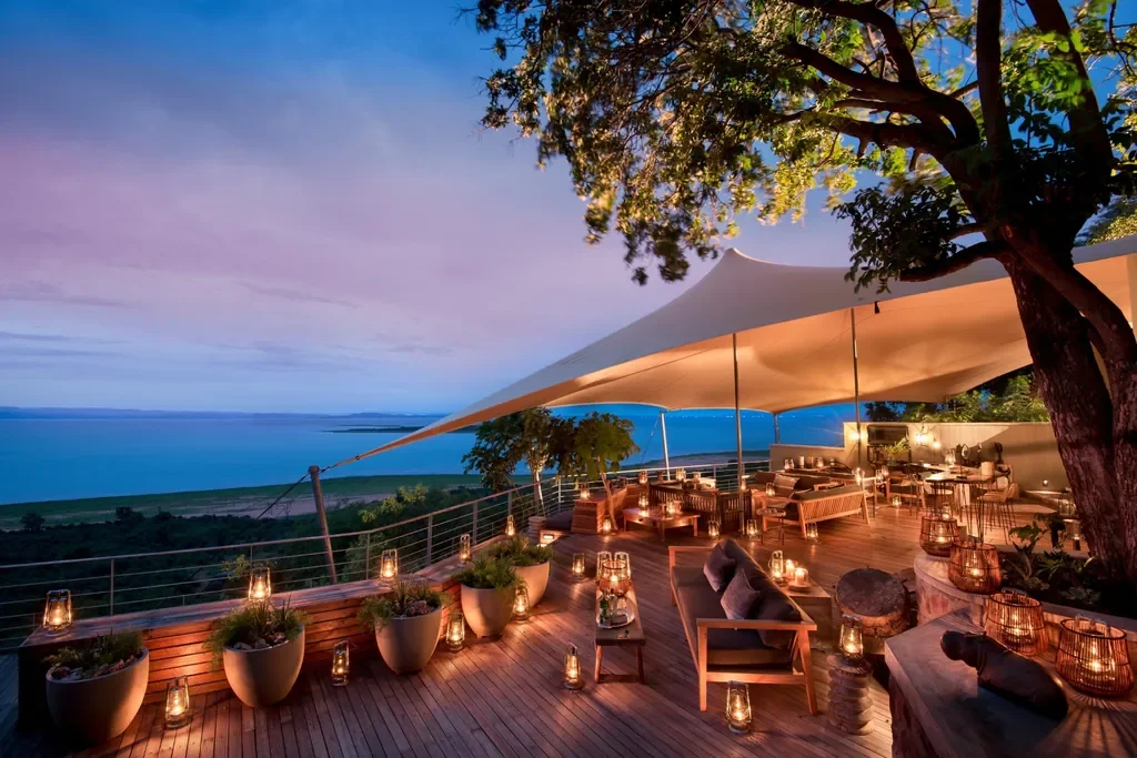 Lantern-lit sunset deck at Bumi Hills Safari Lodge with expansive Lake Kariba views, Zimbabwe