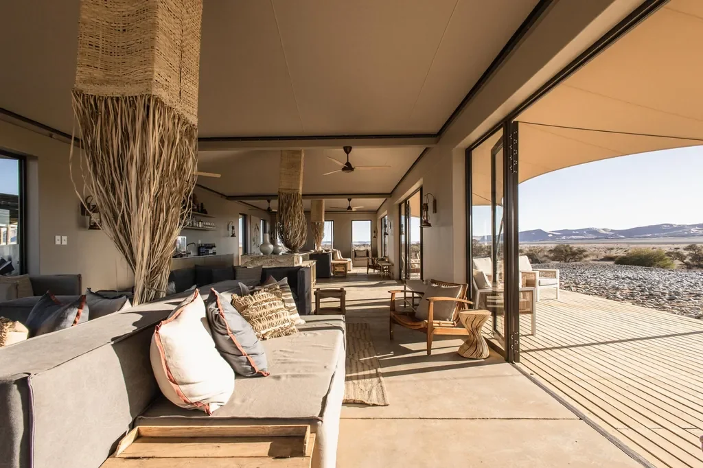 Kulala Desert Lodge open plan lounge and bar with panoramic windows