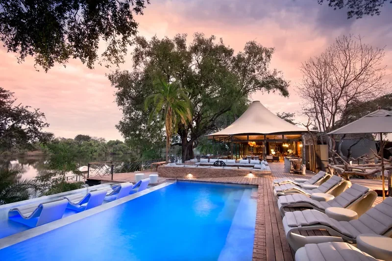 Riverside infinity pool and loungers at Thorntree River Lodge near Victoria Falls, Zambia