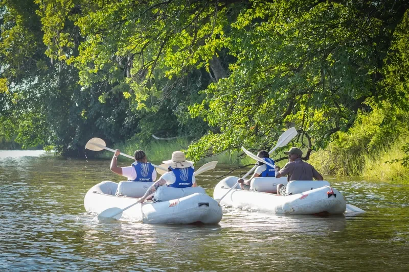 Family canoeing on the Zambezi River with Thorntree River Lodge guides, Zambia