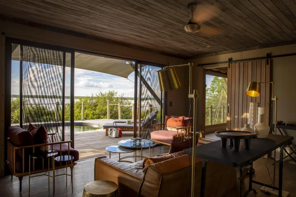 Private suite lounge at DumaTau opening to a deck and plunge pool with wide views of the Linyanti wetlands