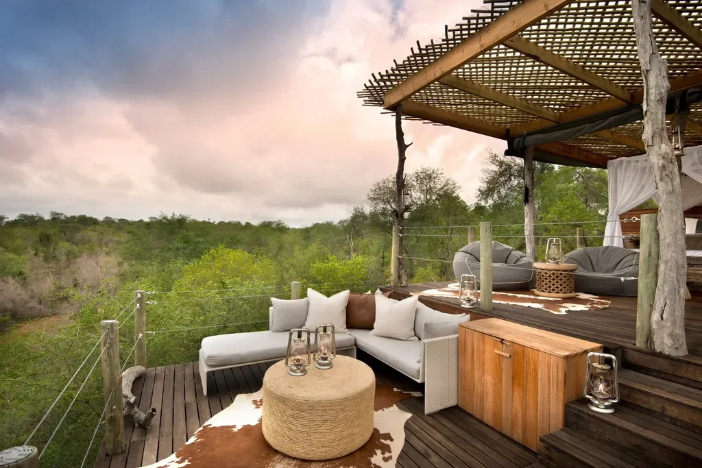 Kingston Treehouse lounge deck with beanbag seating and cowhide rug overlooking the reserve, Sabi Sand