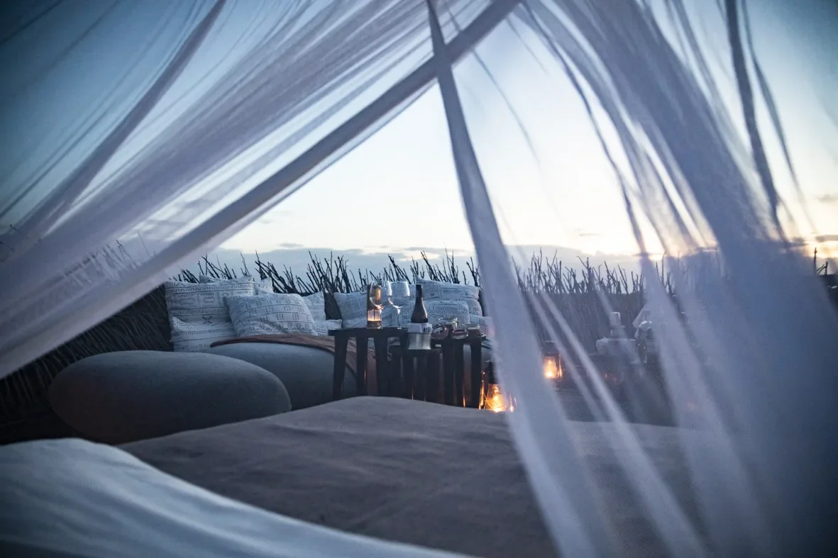 Open air bed and lounge on Nay Palad Bird Nest deck at dusk, Segera, Laikipia, Kenya