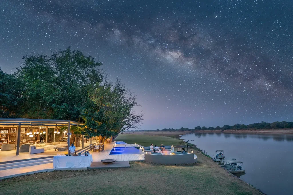 Milky Way above Time + Tide Chinzombo camp and Luangwa River, night sky photography in South Luangwa National Park, Zambia